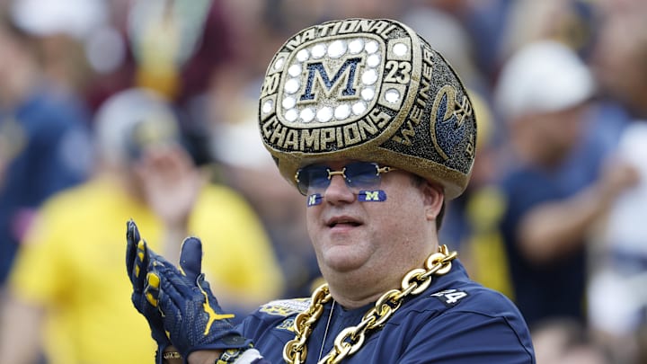 Sep 13, 2025; Ann Arbor, Michigan, USA;  A Michigan Wolverines fan cheers in the first half against the Central Michigan Chippewas at Michigan Stadium. Mandatory Credit: Rick Osentoski-Imagn Images