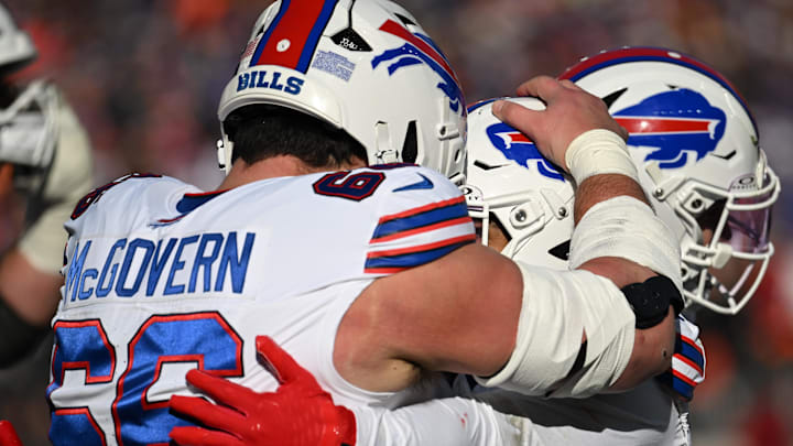Dec 21, 2025; Cleveland, Ohio, USA;  Buffalo Bills running back Ty Johnson (26) gets a hug from center Connor McGovern (66) after scoring a touchdown against the Cleveland Browns during the first half at Huntington Bank Field. Mandatory Credit: Ken Blaze-Imagn Images
