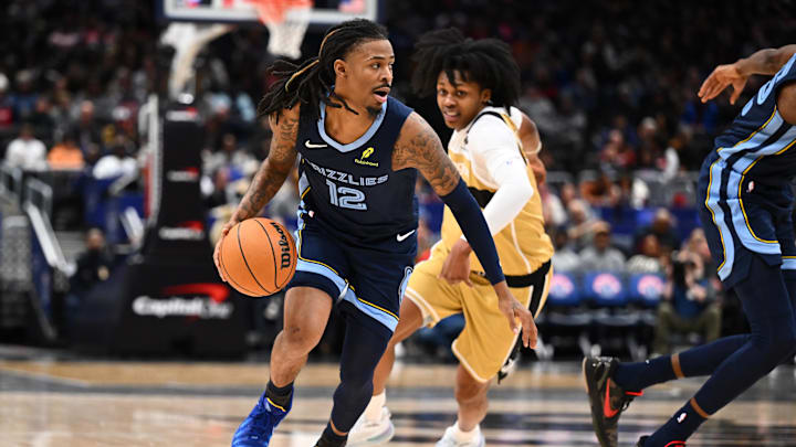 Dec 28, 2025; Washington, District of Columbia, USA; Memphis Grizzlies guard Ja Morant (12) advances the ball as Washington Wizards guard Bub Carrington (7) looks on during the first half at Capital One Arena. Mandatory Credit: Brad Mills-Imagn Images
