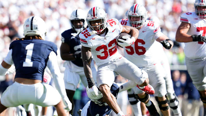 Ohio State Buckeyes running back TreVeyon Henderson (32) runs toward Penn State Nittany Lions safety Jaylen Reed (1) during the first half of the NCAA football game at Beaver Stadium in University Park, Pa. on Saturday, Nov. 2, 2024.