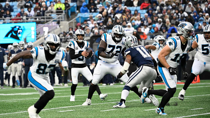 Dec 15, 2024; Charlotte, North Carolina, USA; Carolina Panthers quarterback Bryce Young (9) looks to pass as offensive tackle Taylor Moton (72) blocks and Dallas Cowboys linebacker Micah Parsons (11) rushes in the fourth quarter at Bank of America Stadium. Mandatory Credit: Bob Donnan-Imagn Images