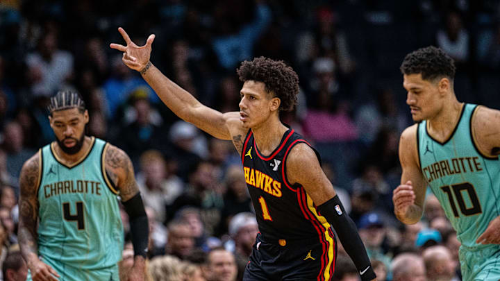 Nov 30, 2024; Charlotte, North Carolina, USA; Atlanta Hawks forward Jalen Johnson (1) celebrates after a three point basket against the Charlotte Hornets in the fourth quarter at Spectrum Center. Mandatory Credit: Scott Kinser-Imagn Images