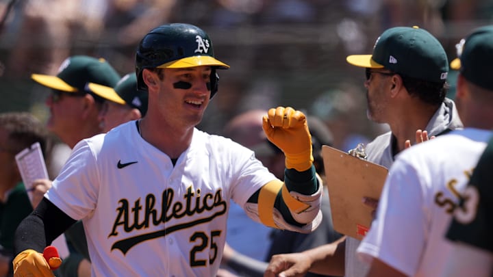 Jun 9, 2024; Oakland, California, USA; Oakland Athletics designated hitter Brent Rooker (25) is congratulated by teammates after hitting a home run against the Toronto Blue Jays during the sixth inning at Oakland-Alameda County Coliseum. Mandatory Credit: Darren Yamashita-USA TODAY Sports