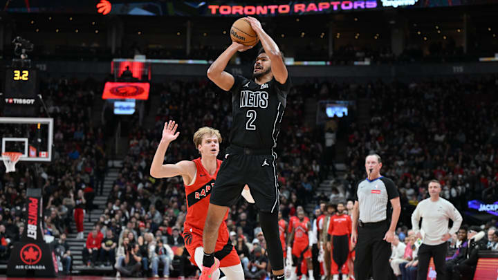 Jan 1, 2025; Toronto, Ontario, CAN;  Brooklyn Nets forward Cam Johnson (2) shoots the ball over Toronto Raptors guard Gradey Dick (1) in the first half at Scotiabank Arena. Mandatory Credit: Dan Hamilton-Imagn Images