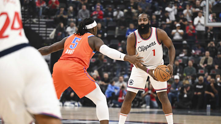 Nov 2, 2024; Inglewood, California, USA; LA Clippers guard James Harden (1) looks to pass against Oklahoma City Thunder guard Luguentz Dort (5) during the first half at Intuit Dome. Mandatory Credit: Jonathan Hui-Imagn Images