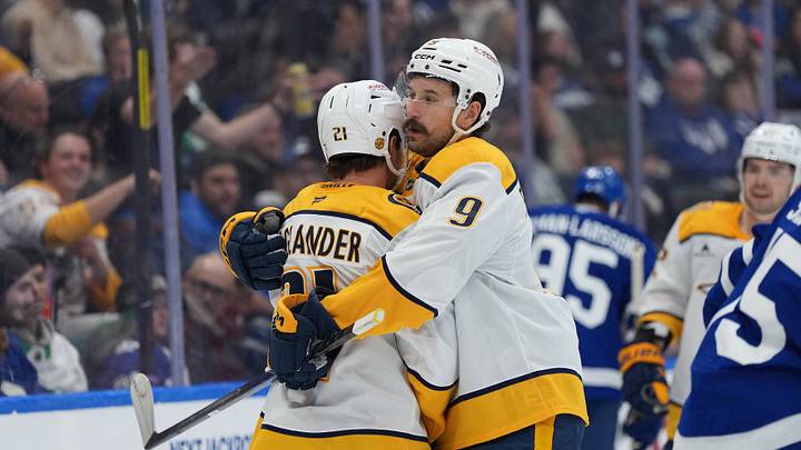 Oct 6, 2026; Toronto, Ontario, CAN;  Nashville Predators left wing Nils Hoglander (21) scores a goal and celebrates with left wing Filip Forsberg (9) against the Toronto Maple Leafs during the second period at Scotiabank Arena.  Mandatory Credit: Nick Turchiaro-Imagn Images