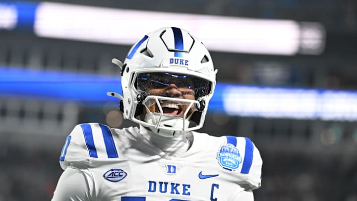 Duke Blue Devils quarterback Darian Mensah (10) celebrates after the Blue Devils score a touchdown in overtime during the  ACC Championship game at Bank of America Stadium. Mandatory Credit: Bob Donnan-Imagn Images