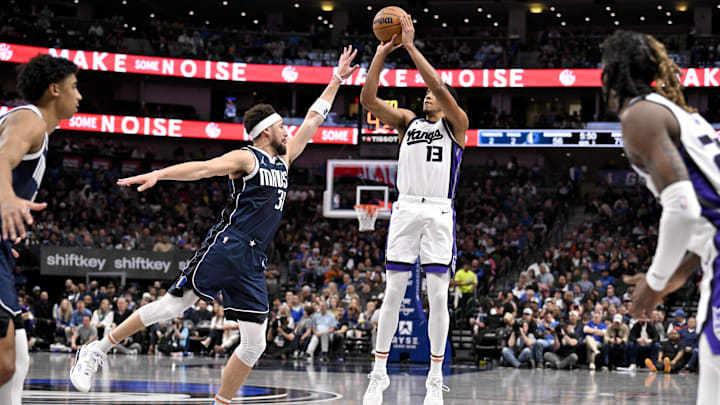 Mar 3, 2025; Dallas, Texas, USA; Sacramento Kings forward Keegan Murray (13) shoots a three point shot over Dallas Mavericks guard Klay Thompson (31) during the second half at the American Airlines Center. Mandatory Credit: Jerome Miron-Imagn Images