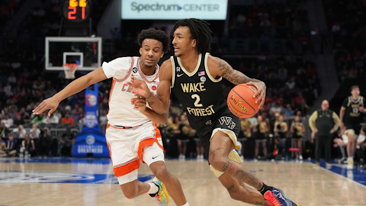 Mar 11, 2026; Charlotte, NC, USA; Wake Forest Demon Deacons forward Juke Harris (2) with the ball as Clemson Tigers guard Efrem Johnson (4) defends in the first half at Spectrum Center. Mandatory Credit: Bob Donnan-Imagn Images