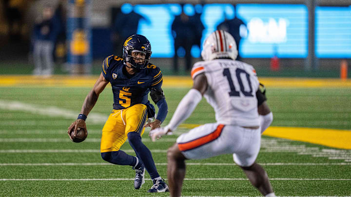 Sep 9, 2023; Berkeley, California, USA; California Golden Bears quarterback Sam Jackson V (5) rushes with the football against Auburn Tigers safety Zion Puckett (10) during the third quarter at California Memorial Stadium. Mandatory Credit: Neville E. Guard-Imagn Images