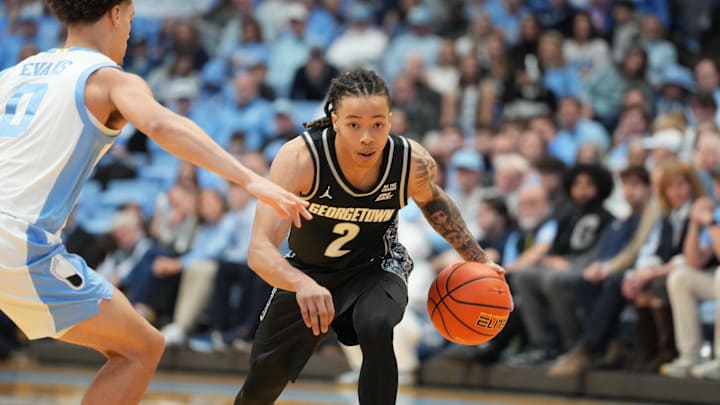 Dec 7, 2025; Chapel Hill, North Carolina, USA;  Georgetown Hoyas guard Malik Mack (2) with the ball as North Carolina Tar Heels guard Kyan Evans (0) defends in the first half at Dean E. Smith Center. Mandatory Credit: Bob Donnan-Imagn Images