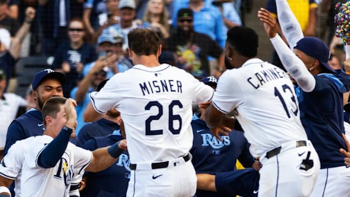 Misner leaps towards home plate and a Rays scrum after hitting a walk-off home run. 