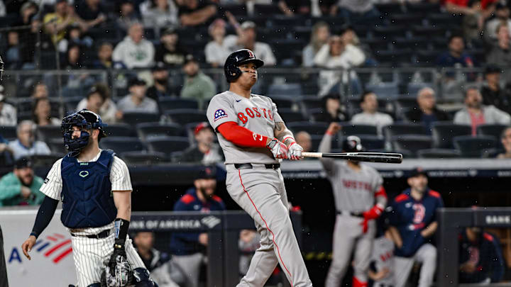 Boston Red Sox designated hitter Rafael Devers (11) reacts after hitting a solo home run against the New York Yankees during the ninth inning at Yankee Stadium in 2025.