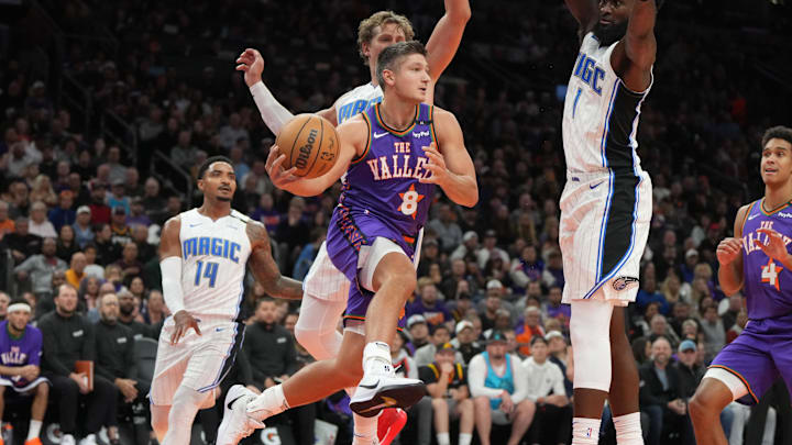 Nov 18, 2024; Phoenix, Arizona, USA; Phoenix Suns guard Grayson Allen (8) makes the pass around Orlando Magic forward Jonathan Isaac (1) during the first half of an NBA game at Footprint Center. Mandatory Credit: Rick Scuteri-Imagn Images