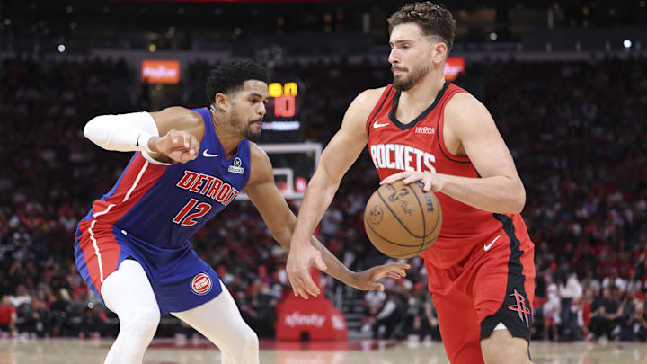 Oct 24, 2025; Houston, Texas, USA; Houston Rockets center Alperen Sengun (28) dribbles the ball as Detroit Pistons forward Tobias Harris (12) defends during the second quarter at Toyota Center. Mandatory Credit: Troy Taormina-Imagn Images