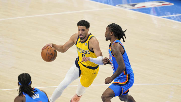Jun 8, 2025; Oklahoma City, Oklahoma, USA; Indiana Pacers guard Tyrese Haliburton (0) dribbles the ball against Oklahoma City Thunder guard Cason Wallace (22) during the first quarter during game two of the 2025 NBA Finals at Paycom Center. Mandatory Credit: Kyle Terada-Imagn Images