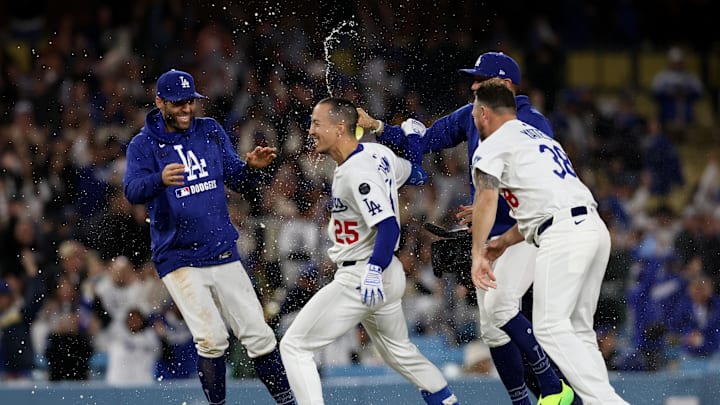 Apr 28, 2025; Los Angeles, California, USA; Los Angeles Dodgers second baseman Tommy Edman (25) celebrates with teammates after hitting a walk off, two-RBI single in the 10th inning against the Miami Marlins at Dodger Stadium. Mandatory Credit: Jason Parkhurst-Imagn Images