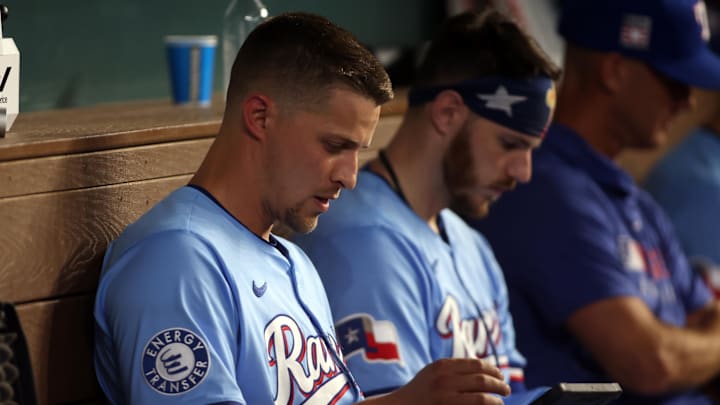 Jul 27, 2025; Arlington, Texas, USA; Texas Rangers shortstop Corey Seager (5) looks at a video while in the dugout during the game against the Atlanta Braves at Globe Life Field.