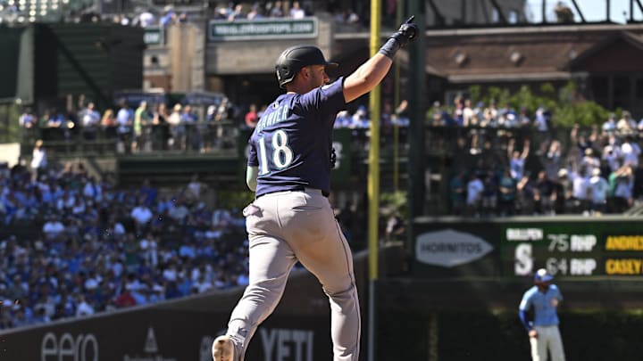 Seattle Mariners designated hitter Mitch Garver (18) points after he hits a three run home run against the Chicago Cubs  during the ninth inning at Wrigley Field on June 20. 