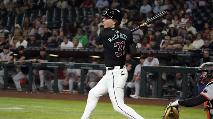 Jun 3, 2024; Phoenix, Arizona, USA; Arizona Diamondbacks outfielder Jake McCarthy (31) hits a double against the San Francisco Giants in the ninth inning at Chase Field. Mandatory Credit: Rick Scuteri-USA TODAY Sports