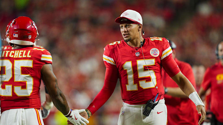 Aug 22, 2025; Kansas City, Missouri, USA; Kansas City Chiefs quarterback Patrick Mahomes (15) congratulates Kansas City Chiefs running back Elijah Mitchell (25) after scoring a touchdown against the Chicago Bears at GEHA Field at Arrowhead Stadium. Mandatory Credit: Jay Biggerstaff-Imagn Images