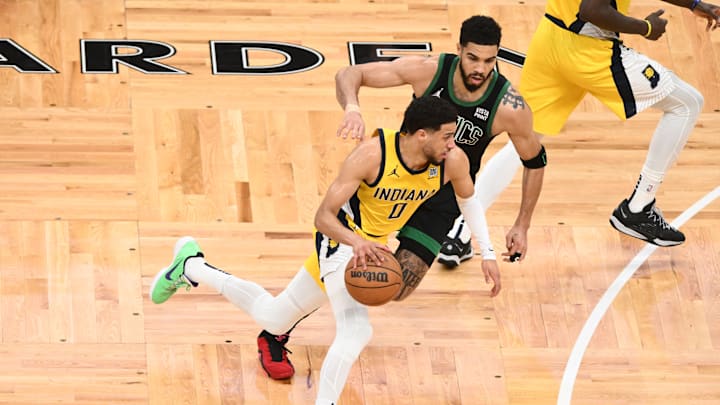 May 23, 2024; Boston, Massachusetts, USA; Indiana Pacers guard Tyrese Haliburton (0) dribbles the ball against Boston Celtics forward Jayson Tatum (0) in the first half during game two of the eastern conference finals for the 2024 NBA playoffs at TD Garden. Mandatory Credit: Brian Fluharty-USA TODAY Sports