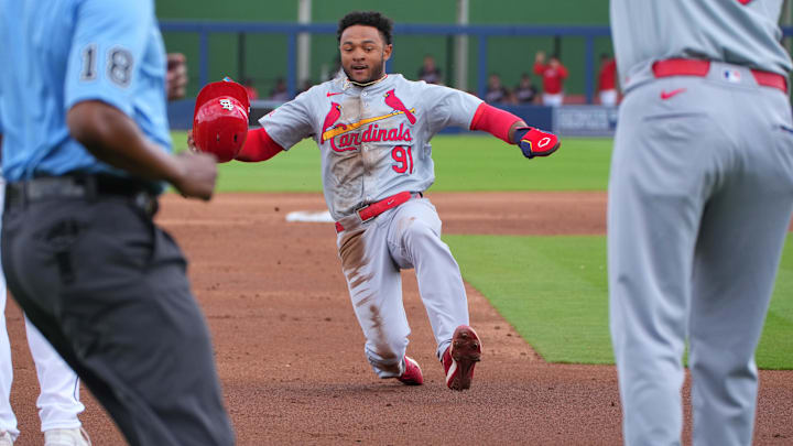 Mar 4, 2024; West Palm Beach, Florida, USA;  St. Louis Cardinals outfielder Victor Scott II slides
