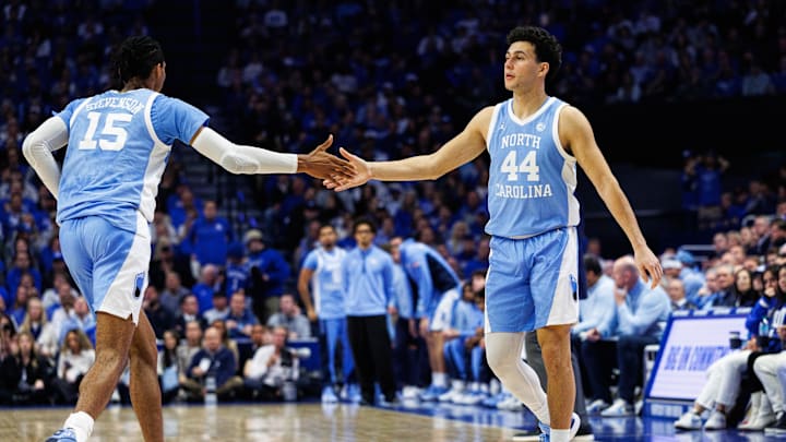 Dec 2, 2025; Lexington, Kentucky, USA; North Carolina Tar Heels guard Luka Bogavac (44) fives forward Jarin Stevenson (15) during the first half against the Kentucky Wildcats at Rupp Arena at Central Bank Center. Mandatory Credit: Jordan Prather-Imagn Images Dec 2, 2025; Lexington, Kentucky, USA; North Carolina Tar Heels guard Luka Bogavac (44) fives forward Jarin Stevenson (15) during the first half against the Kentucky Wildcats at Rupp Arena at Central Bank Center. Mandatory Credit: Jordan Prather-Imagn Images