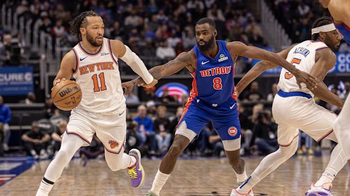 Apr 10, 2025; Detroit, Michigan, USA; New York Knicks guard Jalen Brunson (11) moves the ball up court in front of Detroit Pistons forward Tim Hardaway Jr. (8) during the first half at Little Caesars Arena. Mandatory Credit: David Reginek-Imagn Images