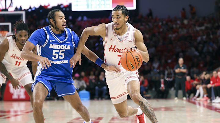 Dec 29, 2025; Houston, Texas, USA; Houston Cougars guard Milos Uzan (7) drives witht the ball as Middle Tennessee Blue Raiders guard Sean Smith (55) defends during the first half at Fertitta Center. 