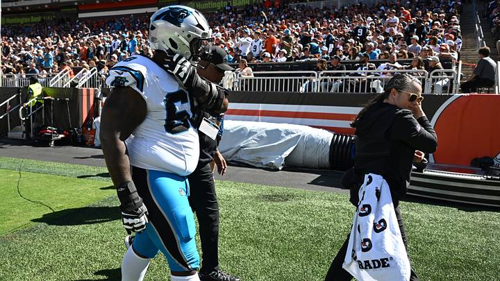 Carolina Panthers guard Damien Lewis (68) walks off the field with medical staff Carolina Panthers guard Damien Lewis (68) walks off the field with medical staff