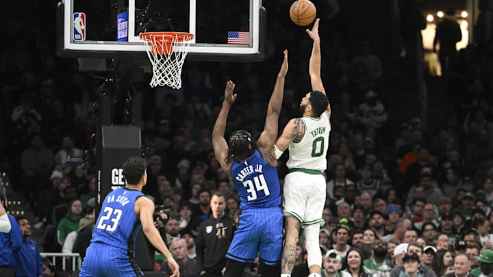 Boston Celtics forward Jayson Tatum (0) shoots over Orlando Magic center Wendell Carter Jr. (34) during the first half at TD Garden.