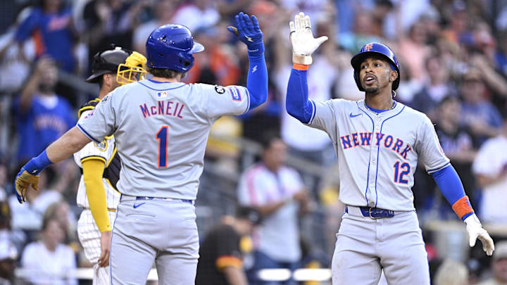 Aug 24, 2024; San Diego, California, USA; New York Mets shortstop Francisco Lindor (12) is congratulated by second baseman Jeff McNeil (1) after hitting a grand slam home run against the San Diego Padres during the fourth inning at Petco Park. Mandatory Credit: Orlando Ramirez-Imagn Images