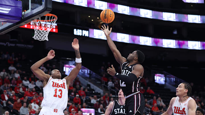 Mississippi State Bulldogs guard Josh Hubbard (12) prepares to lay the ball up against Utah Utes forward Kendyl Sanders (13) during the first half at Delta Center.