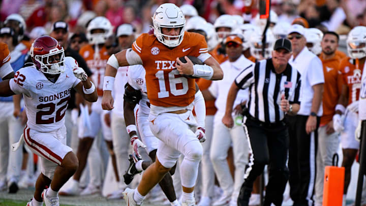 Oct 11, 2025; Dallas, Texas, USA; Texas Longhorns quarterback Arch Manning (16) runs for a first down against the Oklahoma Sooners during the second half at the Cotton Bowl. Mandatory Credit: Jerome Miron-Imagn Images