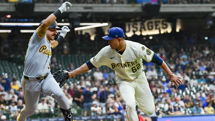 Aug 11, 2025; Milwaukee, Wisconsin, USA; Milwaukee Brewers starting pitcher Jose Quintana (62) attempts to tag Pittsburgh Pirates second baseman Nick Gonzales (39) in the sixth inning at American Family Field. Mandatory Credit: Benny Sieu-Imagn Images