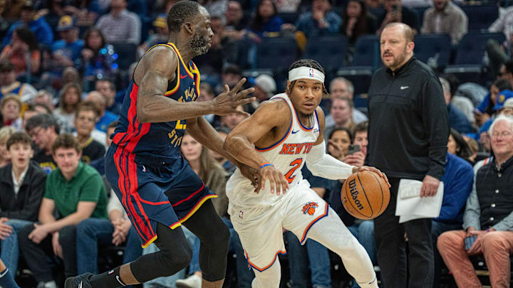 Mar 15, 2025; San Francisco, California, USA; New York Knicks guard Miles McBride (2) drives the the net against Golden State Warriors forward Draymond Green (23) during the second quarter at Chase Center. Mandatory Credit: Neville E. Guard-Imagn Images