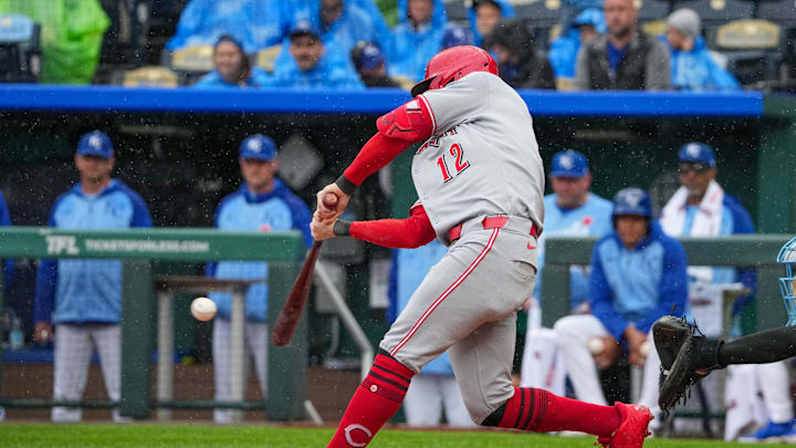 May 26, 2025; Kansas City, Missouri, USA; Cincinnati Reds left fielder Austin Hays (12) hits a one run sacrifice fly against the Kansas City Royals in the first inning at Kauffman Stadium. Mandatory Credit: Denny Medley-Imagn Images
