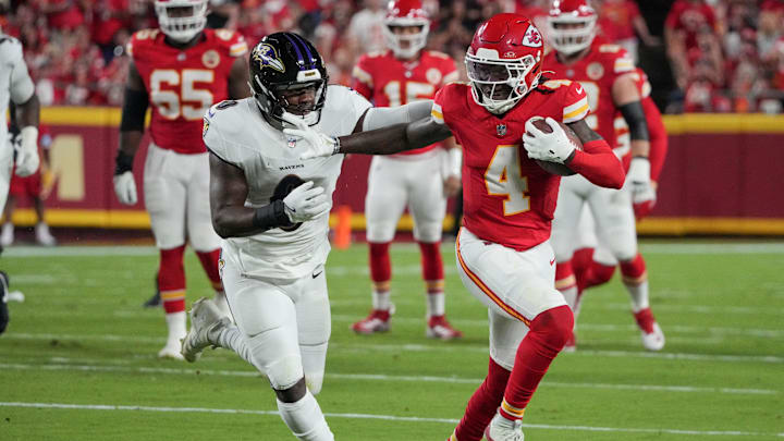 Sep 5, 2024; Kansas City, Missouri, USA; Kansas City Chiefs wide receiver Rashee Rice (4) runs the ball as Baltimore Ravens linebacker Roquan Smith (0) attempts the tackle during the game at GEHA Field at Arrowhead Stadium.