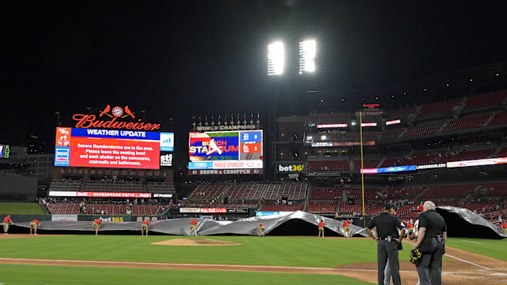 May 19, 2025; St. Louis, Missouri, USA;  St. Louis Cardinals grounds crew pulls the tarp on the field as weather moves towards Busch Stadium during the seventh inning between the St. Louis Cardinals and the Detroit Tigers. Mandatory Credit: Jeff Curry-Imagn Images