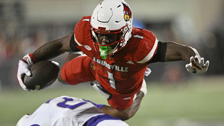 Sep 5, 2025; Louisville, Kentucky, USA; Louisville Cardinals running back Isaac Brown (1) is upended by James Madison Dukes cornerback Elijah Culp (2) during the first half at L&N Federal Credit Union Stadium. Mandatory Credit: Jamie Rhodes-Imagn Images Sep 5, 2025; Louisville, Kentucky, USA; Louisville Cardinals running back Isaac Brown (1) is upended by James Madison Dukes cornerback Elijah Culp (2) during the first half at L&N Federal Credit Union Stadium. Mandatory Credit: Jamie Rhodes-Imagn Images