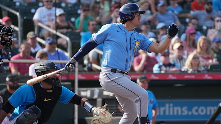Mar 11, 2023; Jupiter, Florida, USA;  Tampa Bay Rays third baseman Austin Shenton (93) hits a double against the Miami Marlins in the third inning at Roger Dean Stadium. Mandatory Credit: Jim Rassol-Imagn Images