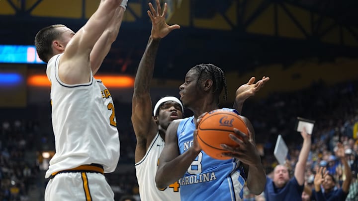Jan 17, 2026; Berkeley, California, USA; North Carolina Tar Heels forward Caleb Wilson (8) is double teamed by California Golden Bears forward John Camden (left) and forward Lee Dort (center back) during the first half at Haas Pavilion. Mandatory Credit: Darren Yamashita-Imagn Images