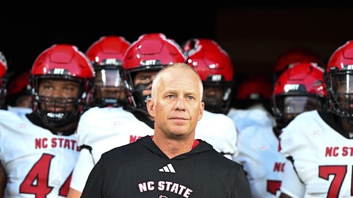 Sep 11, 2025; Winston-Salem, North Carolina, USA;  North Carolina State Wolfpack head coach Dave Doeren walks his team out on the field against the Wake Forest Demon Deacons at Allegacy Federal Credit Union Stadium. Mandatory Credit: Luke Jamroz-Imagn Images