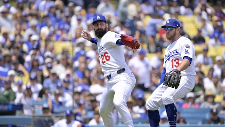 Apr 30, 2025; Los Angeles, California, USA; Los Angeles Dodgers starting pitcher Tony Gonsolin (26) throws out Miami Marlins shortstop Xavier Edwards (9) at first base after a bunt during the third inning at Dodger Stadium. Mandatory Credit: Jayne Kamin-Oncea-Imagn Images