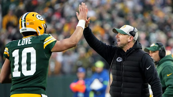 Green Bay Packers quarterback Jordan Love (10) high fives head coach Matt LaFleur after throwing a TD pass against the Bears.