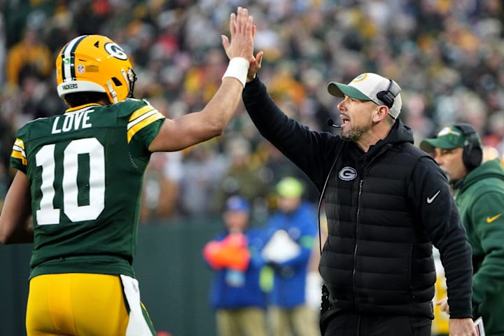 Green Bay Packers quarterback Jordan Love (10) high-fives coach Matt LaFleur after throwing a touchdown pass vs. the Bears.