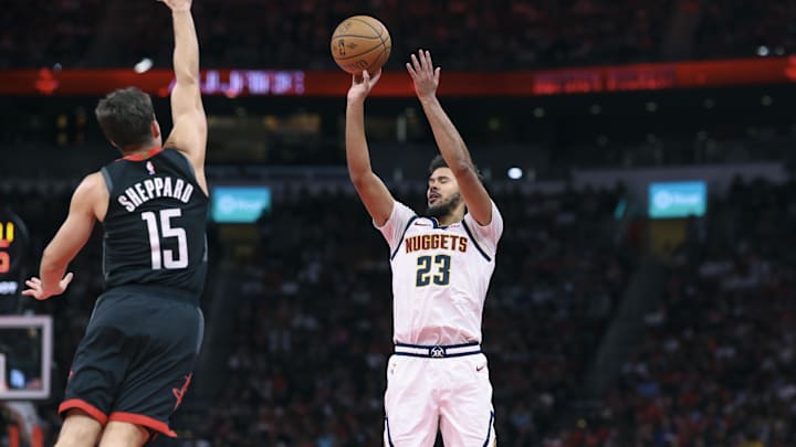 Nov 21, 2025; Houston, Texas, USA; Denver Nuggets forward Cameron Johnson (23) shoots the ball as Houston Rockets guard Reed Sheppard (15) defends during the fourth quarter at Toyota Center. Mandatory Credit: Troy Taormina-Imagn Images