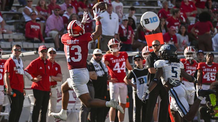 Aug 30, 2025; Bloomington, Indiana, USA; Indiana Hoosiers wide receiver Elijah Sarratt (13) catches a pass in front of Old Dominion Monarchs cornerback Brandon Crutchfield (5) during the second half at Memorial Stadium. Mandatory Credit: Robert Goddin-Imagn Images