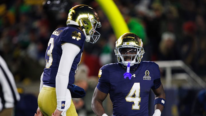 Notre Dame running back Jeremiyah Love (4) and quarterback Riley Leonard (13) celebrate a Love touchdown during the first round of the College Football Playoff between Notre Dame and Indiana at Notre Dame Stadium on Friday, Dec. 20, 2024, in South Bend.